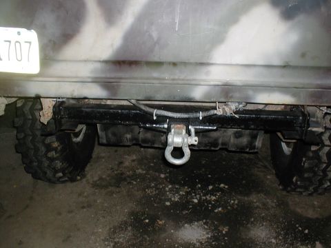 1979 Ford Bronco - Close-up of a vehicle's rear bumper, showing a tow hitch and off-road tire.