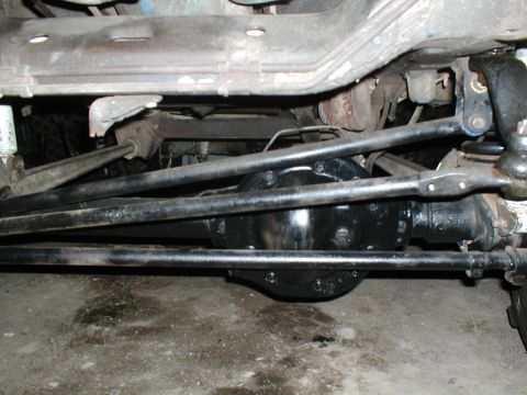 1979 Ford Bronco - Close-up view of a vehicle's undercarriage, focusing on the differential and steering components.