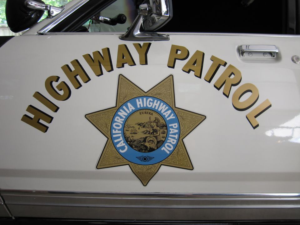 White police car door with HIGHWAY PATROL text and California Highway Patrol star