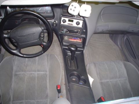 1994 Ford Thunderbird - Interior view of a 1994 Ford Thunderbird, the dashboard, steering wheel, and front seats.