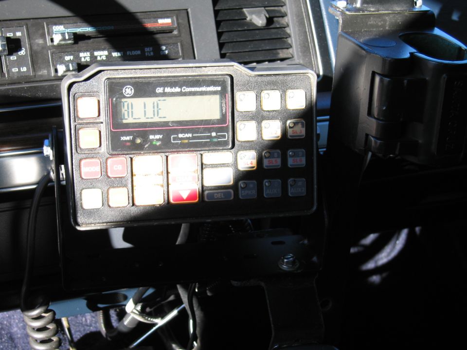 Close-up of a GE Mobile Communications two-way radio control head mounted in a vehicle