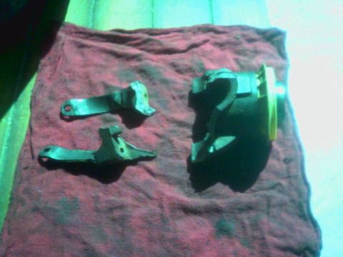 1987 Ford Bronco - Automotive parts, possibly from a drivetrain, resting on a red shop rag.