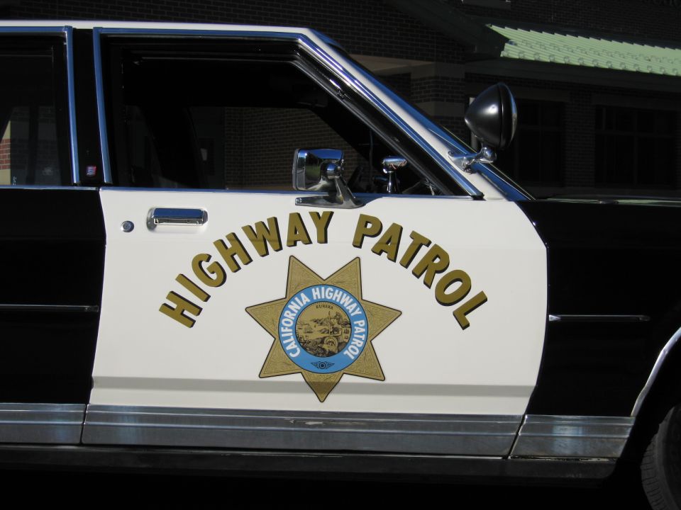Close-up of CALIFORNIA HIGHWAY PATROL door with gold seven-point star emblem