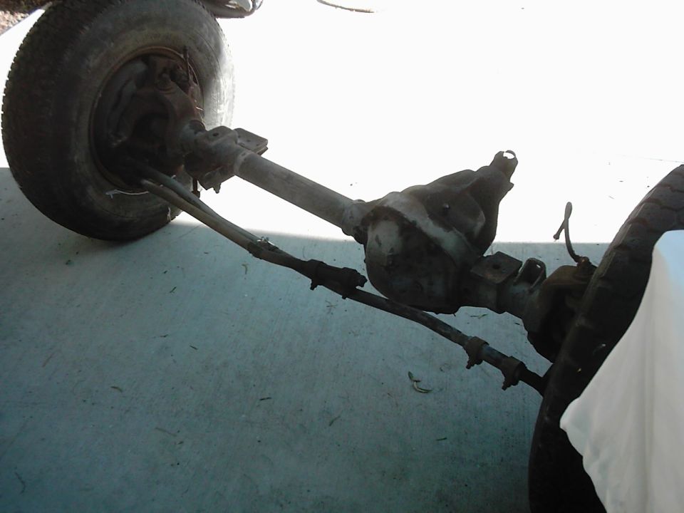 Front axle and steering linkage with tire