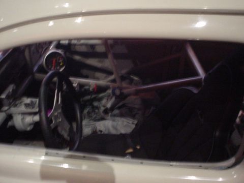 1968 Ford Mustang - Custom interior with roll cage and racing seat, view through the window.