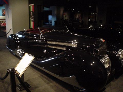 1968 Ford Mustang - A classic black convertible is displayed indoors, likely in a museum, with a plaque providing information about the vehicle.