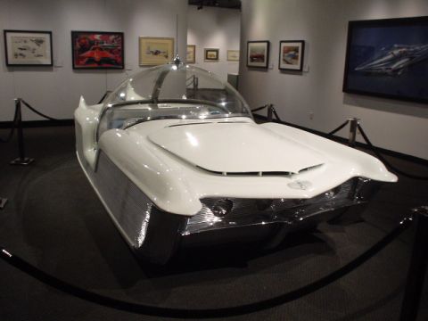 1968 Ford Mustang - A futuristic concept car with a distinctive bubble canopy is on display at a museum.