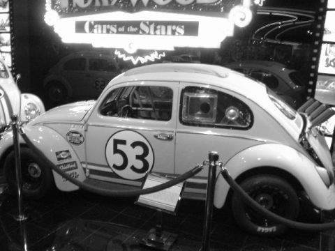 1968 Ford Mustang - A famous movie car, Herbie the Love Bug, is displayed with other vehicles in a museum setting.