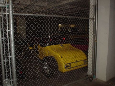 1968 Ford Mustang - A yellow custom car fender is visible behind a chain-link fence.