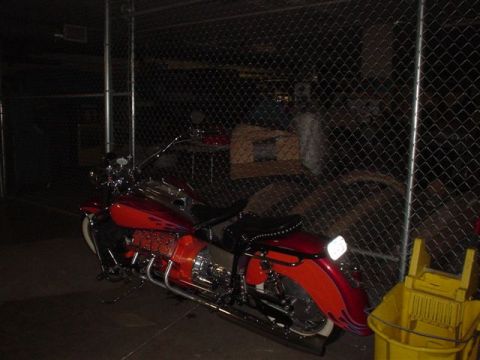 1968 Ford Mustang - A custom red motorcycle with flame decals is parked outdoors at night.
