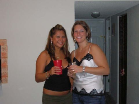 1991 Ford Bronco - Two women pose for a photo while holding drinks in what appears to be a casual indoor setting.