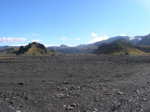 2001 Jeep Wrangler - A vast, rocky terrain stretches towards distant mountains under a clear blue sky.