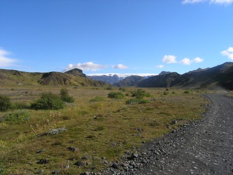 2001 Jeep Wrangler - Expansive Icelandic landscape with a winding gravel road and mountains in the distance.