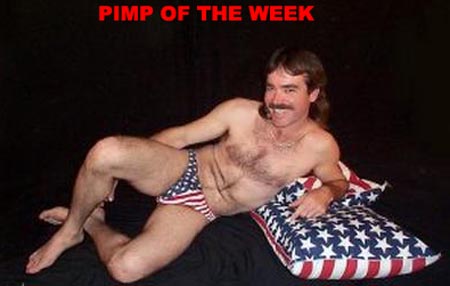 1991 Ford Bronco - Man in American flag bikini briefs reclines on a star-spangled pillow against a black backdrop.