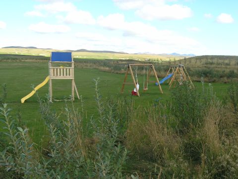 2001 Jeep Wrangler - Outdoor playground scene with multiple play structures set against a backdrop of rolling hills.