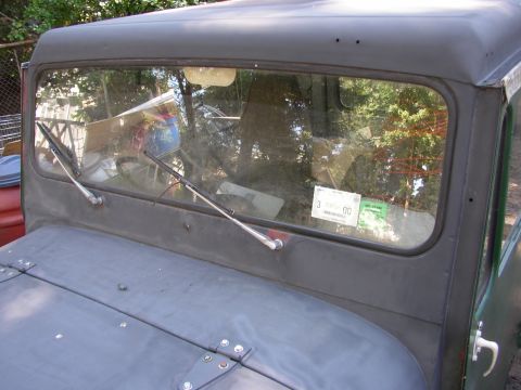 1973 Jeep CJ5 - Front view of a 1973 Jeep CJ5, showing the windshield with an inspection sticker and wipers.