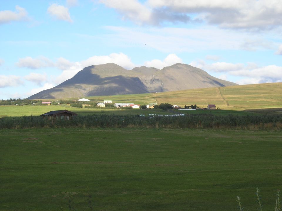 Rural landscape with mountains and buildings