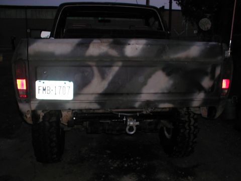 1979 Ford Bronco - This pickup truck features a camouflage paint job and a visible license plate.