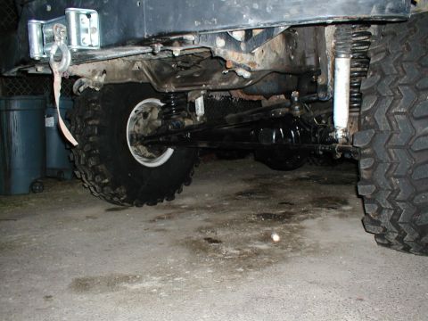 1979 Ford Bronco - The underside of an off-road vehicle shows its heavy-duty suspension and drivetrain components.
