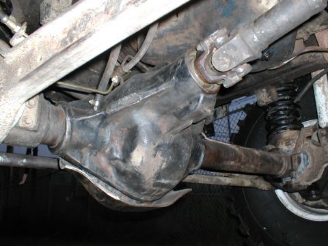 1979 Ford Bronco - Underside view of a vehicle's rear differential and driveshaft assembly, showing the U-joint connection.