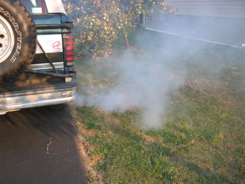 1992 Ford Bronco - Exhaust smoke billows from the rear of a 1992 Ford Bronco.