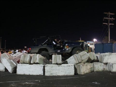 2001 Mercury Grand Marquis - A Jeep CJ-7 navigates an obstacle course made of concrete blocks during an nighttime event.