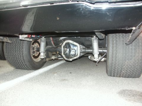 2001 Mercury Grand Marquis - The rear axle and wide tires of a modified car are visible from underneath.