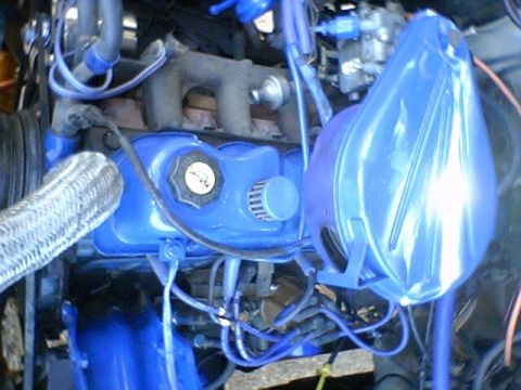 1986 Ford Bronco - Close-up view of an engine bay with various components painted bright blue.