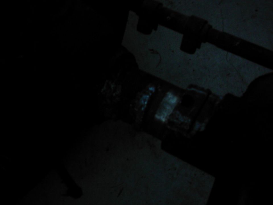 Close-up of an exhaust pipe clamp with visible banding