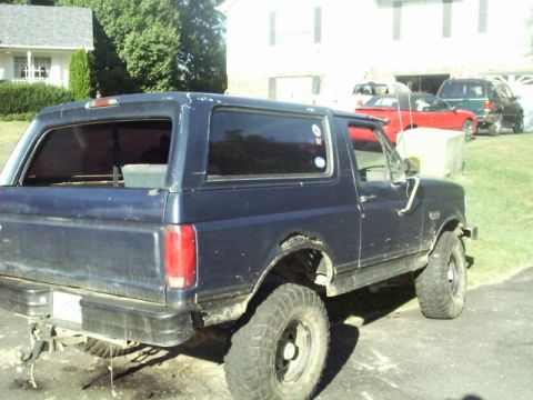 1992 Ford Bronco - This 1992 Ford Bronco is equipped with large off-road tires and appears to be in a residential setting.