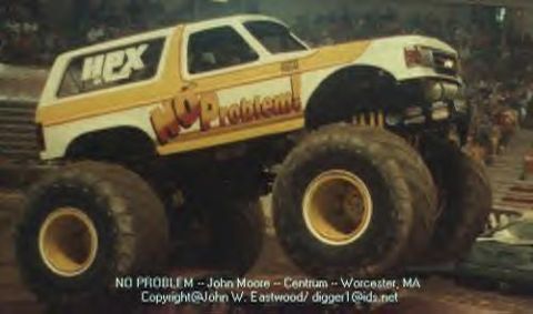 1993 Ford Bronco - Monster truck with "NO PROBLEM!" graphics and "HPX" on the side, seen in an arena.