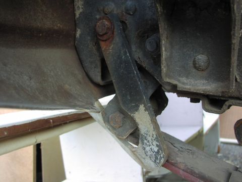 1983 Ford F-250 - Close-up view of a rusty metal bracket on a vehicle's undercarriage.