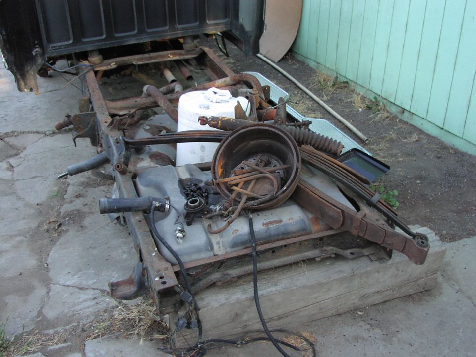 Truck chassis with fuel tank and suspension parts