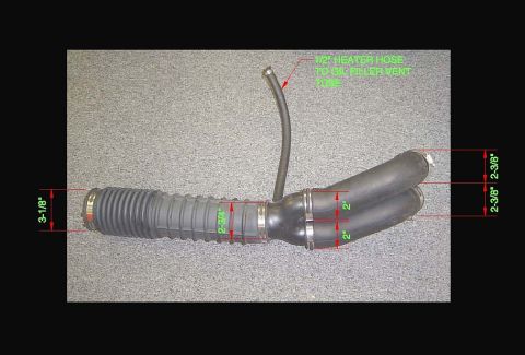 1986 Ford Bronco - Annotated reference photo of a rubber air intake tube assembly with a bellows section and twin outlet branches, laid on gray carpet. Red di…