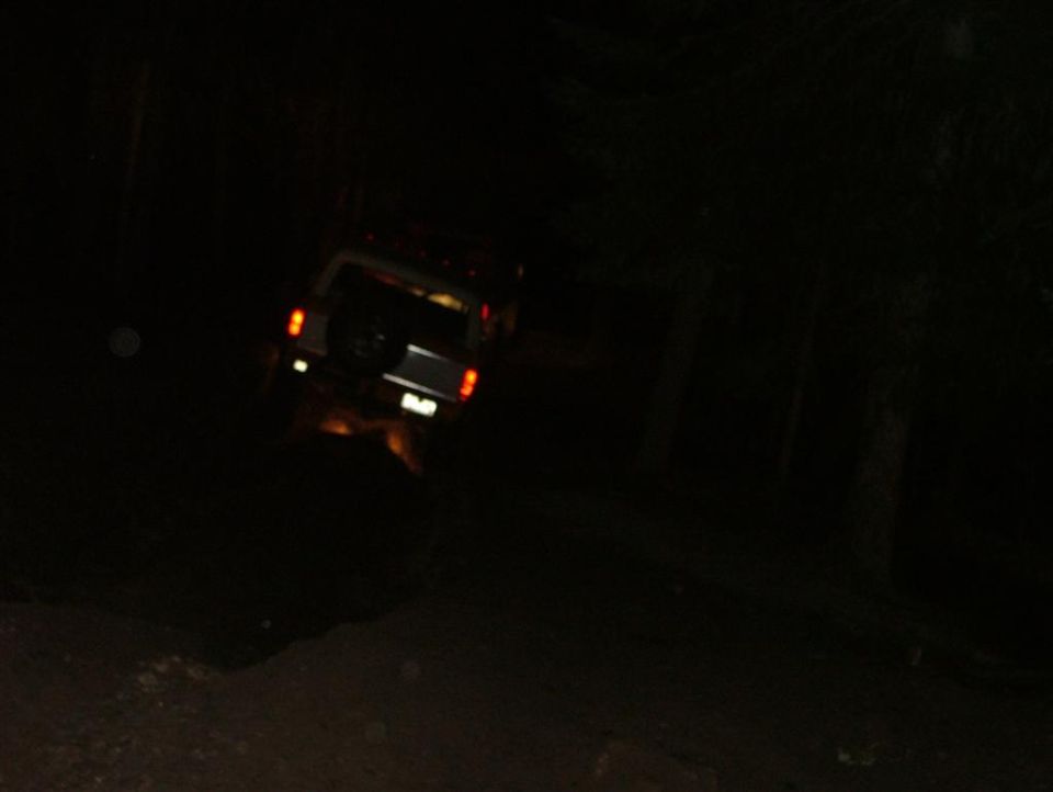 1989 Dodge Power Ram SUV, white, rear view, spare tire on door, taillights illuminated