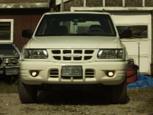 White 2000 Isuzu Rodeo front view with fog lights and license plate 199-BZI