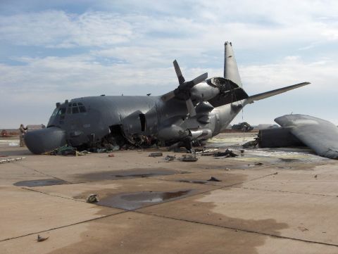 1988 Ford Bronco - A damaged military transport aircraft sits on an airfield with its wing broken off.