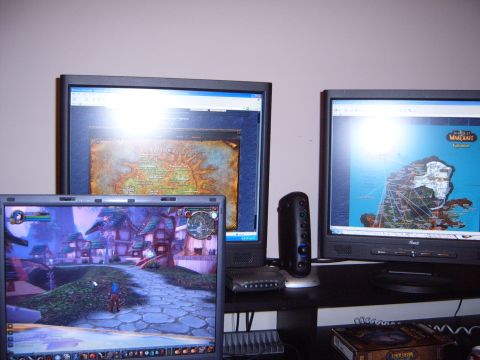 1988 Ford Bronco - Computer setup with multiple screens showing fantasy game worlds and maps.