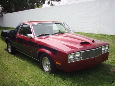 1970 Ford Ranchero - Customized Ford Ranchero with flame decals and a hood scoop is parked on a grassy lawn.