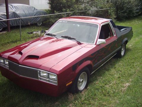 1970 Ford Ranchero - This customized pickup truck, likely from the early 1980s, features a distinctive hood and flame graphics.