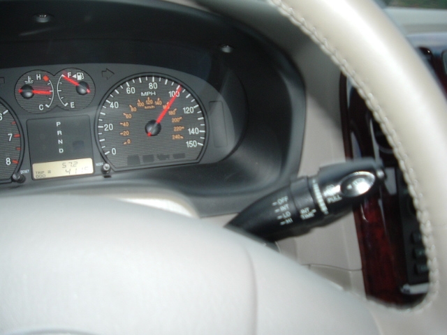 Instrument cluster with 150-mph speedometer and PRND selector, beige woodgrain dash