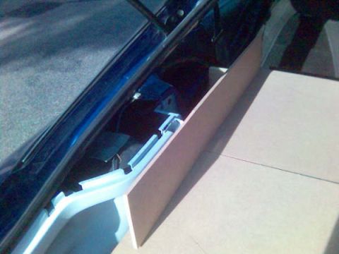 1994 Ford Probe - Installation of a tan interior panel in a blue vehicle.