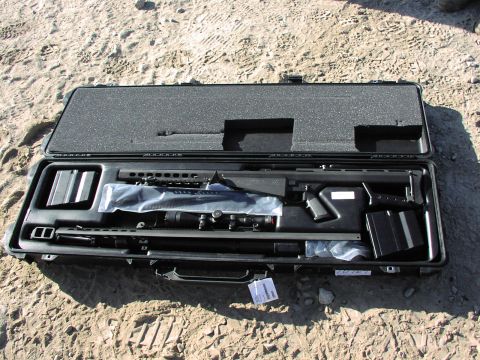 1979 Ford Bronco - A disassembled sniper rifle, complete with scope and extra magazines, is neatly organized within its protective carrying case.