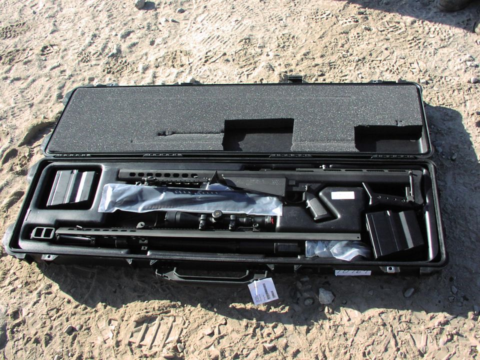 Sniper rifle with scope and extra magazine in a black case