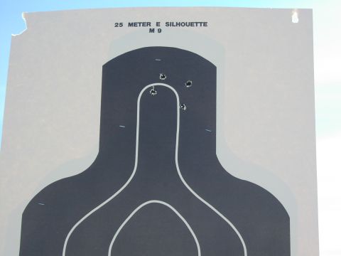 1979 Ford Bronco - A target silhouette shows bullet impacts near the center mass area.
