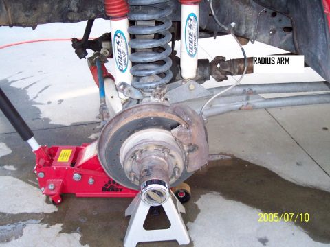 1985 Ford Bronco - Close-up view of a vehicle's front suspension and brake assembly, with a radius arm clearly labeled.