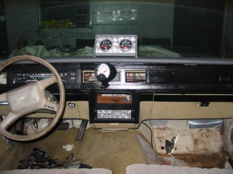 1985 Ford LTD Crown Victoria - Interior view of a 1985 Ford Crown Victoria LTD, a steering wheel, dashboard, and aftermarket gauges.
