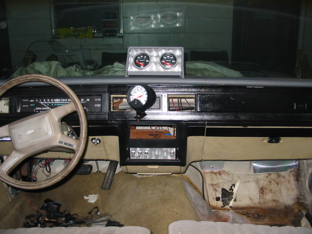 Interior of 1985 Ford Crown Victoria LTD with aftermarket tachometer and dual gauges