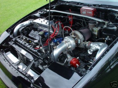 1992 Ford Probe - A heavily modified engine bay features a turbocharger and custom intake piping.