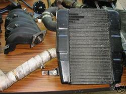 1992 Ford Probe - A radiator and intake manifold are laid out on a wooden surface.